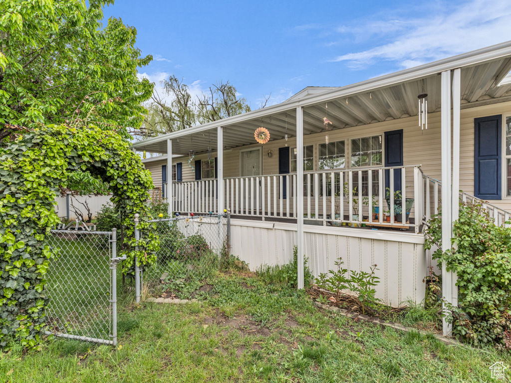 View of front of house with covered porch and fence