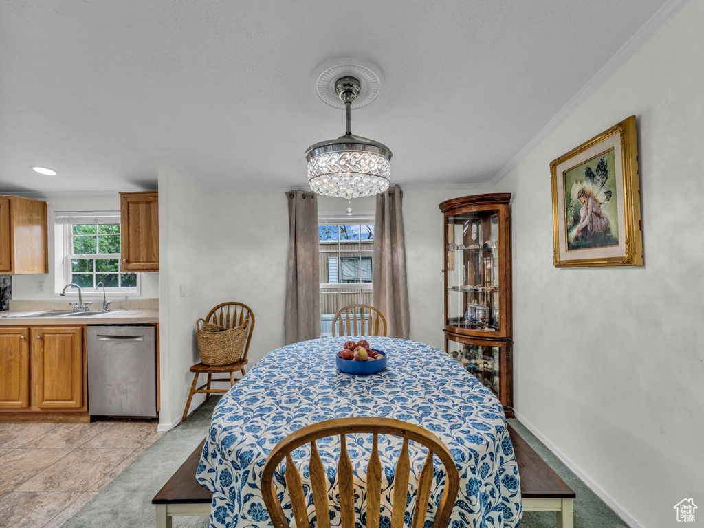 Dining space featuring ornamental molding, a chandelier, and baseboards