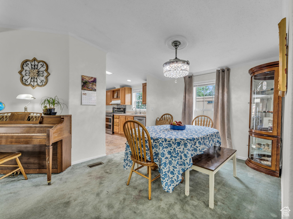 Dining space with light carpet and baseboards
