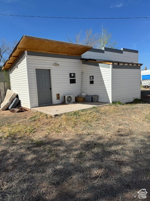 Back of property with a patio and ac unit