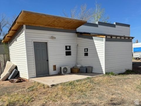 Back of property with a patio and ac unit