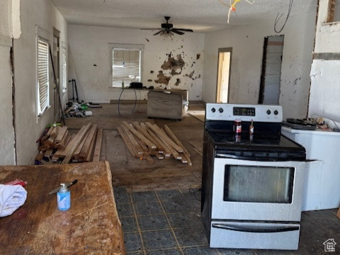 Kitchen with a ceiling fan, electric range, and open floor plan