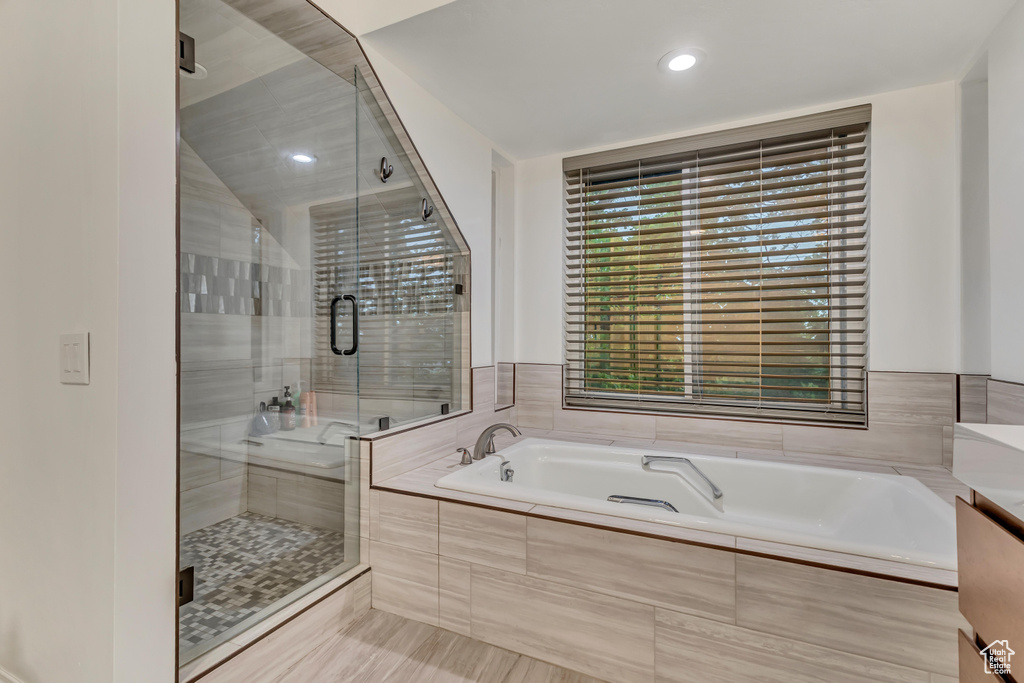 Full bath with tile patterned floors, a garden tub, a stall shower, and recessed lighting