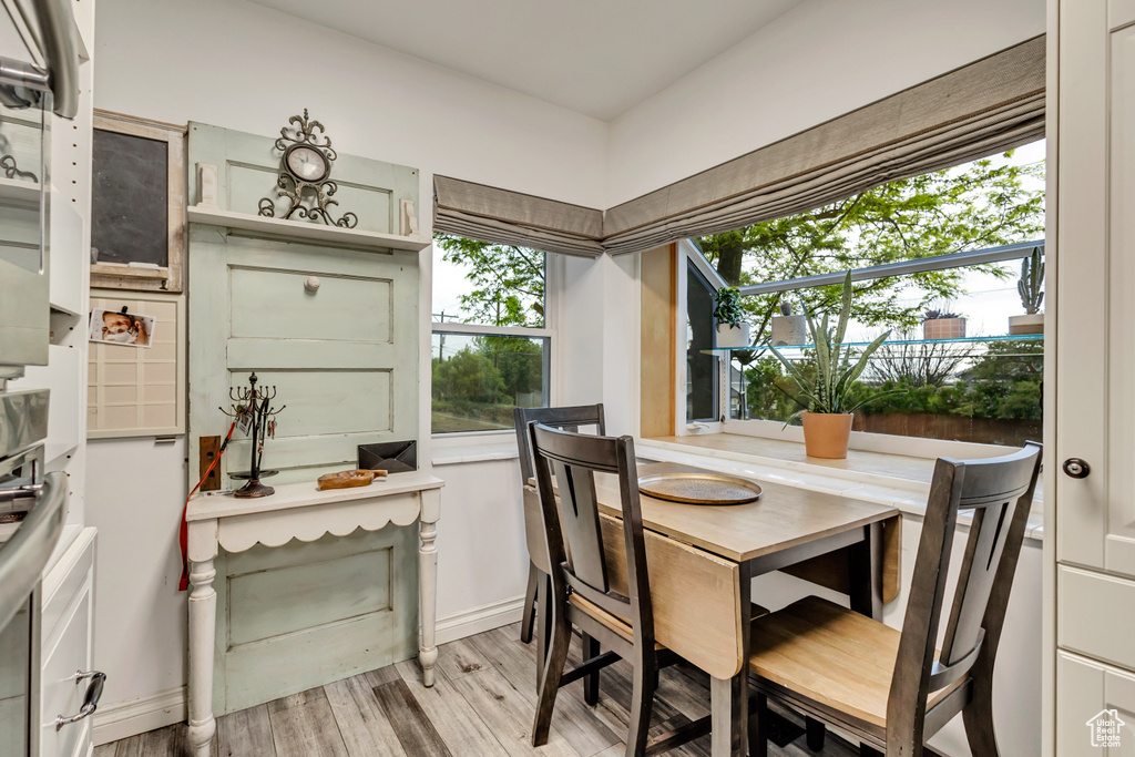 Dining space with baseboards and light wood finished floors