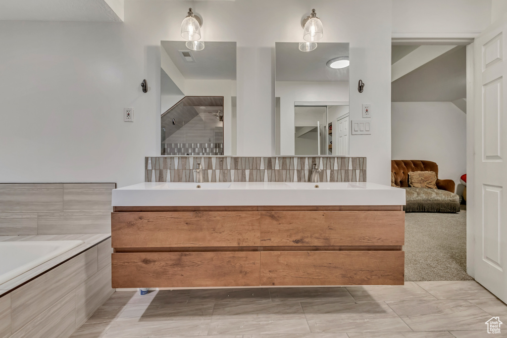 Bathroom with double vanity and visible vents