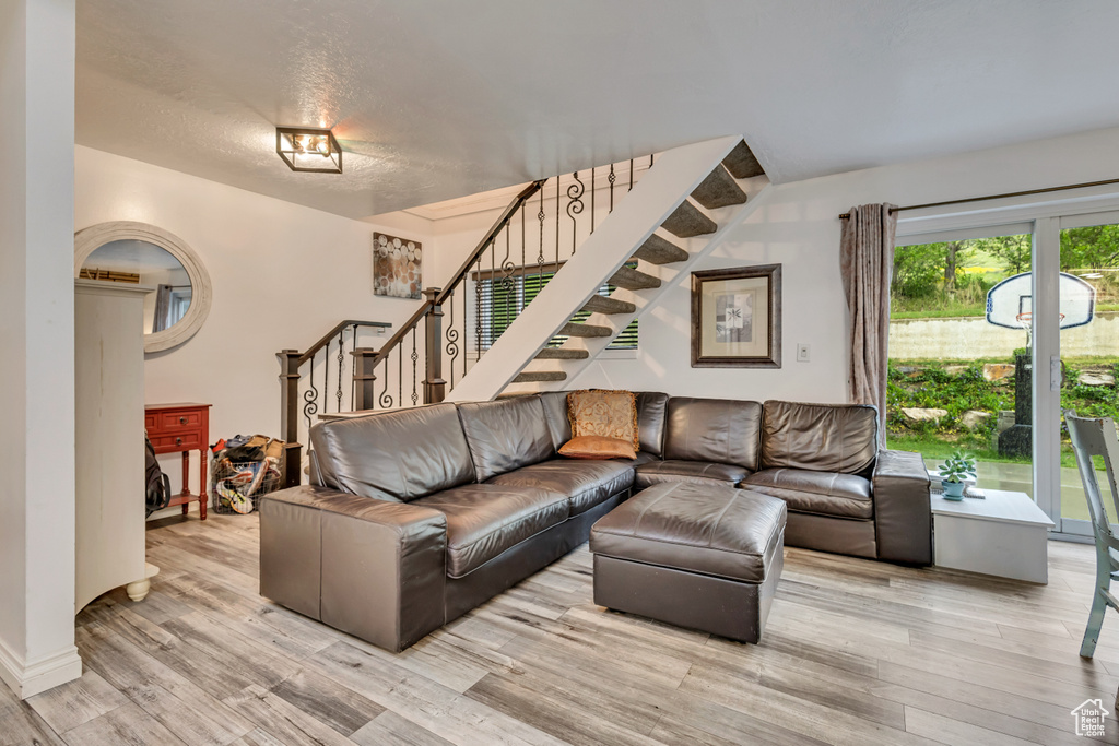 Living area featuring stairs and wood finished floors