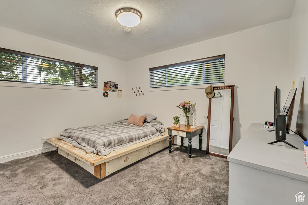 Carpeted bedroom featuring baseboards