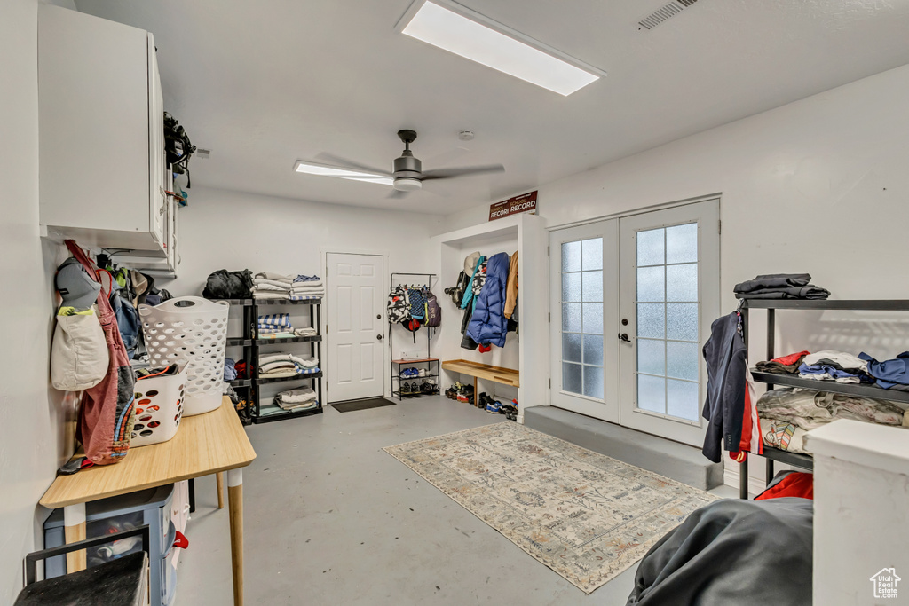 Mudroom featuring finished concrete floors, visible vents, french doors, and ceiling fan