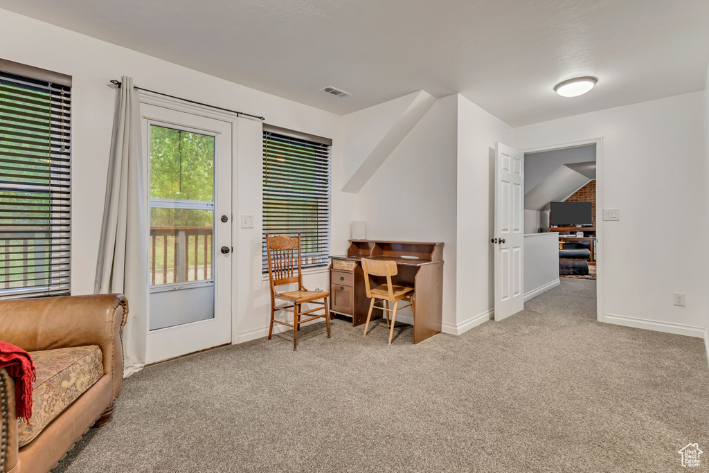 Home office with baseboards, visible vents, and carpet floors