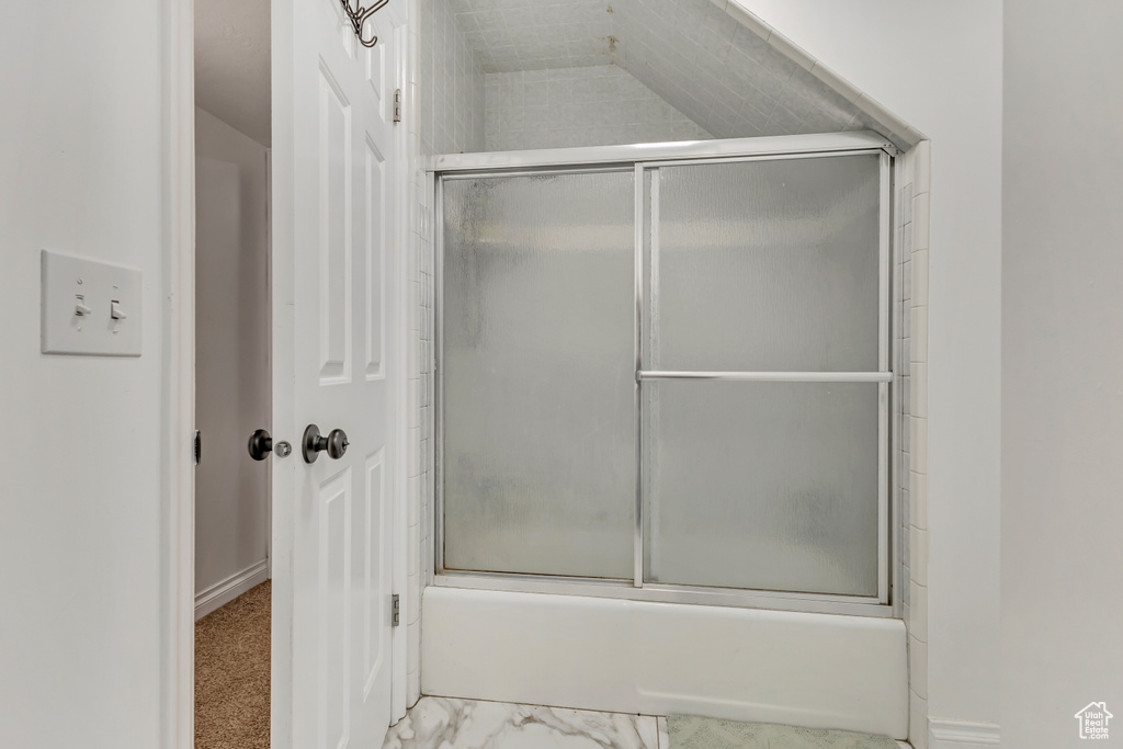 Full bathroom featuring bath / shower combo with glass door