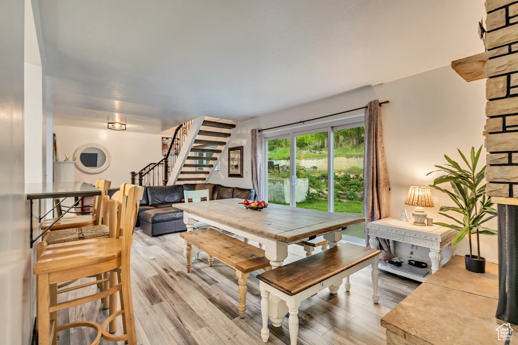 Dining room featuring stairs and light wood-style floors