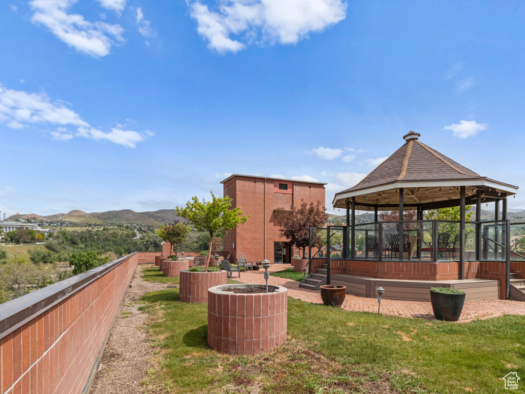 Surrounding community with a gazebo and a mountain view