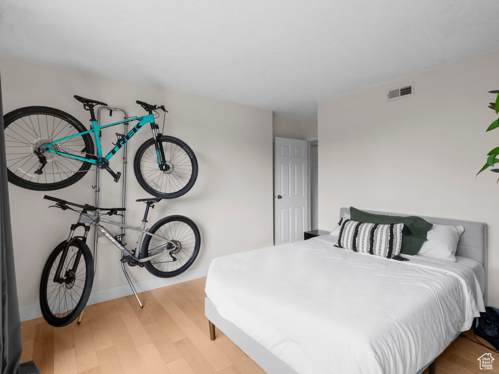 Bedroom featuring wood finished floors and baseboards