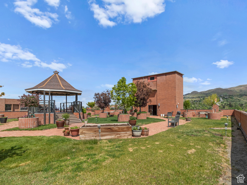 View of yard with a gazebo, a mountain view, and a patio area