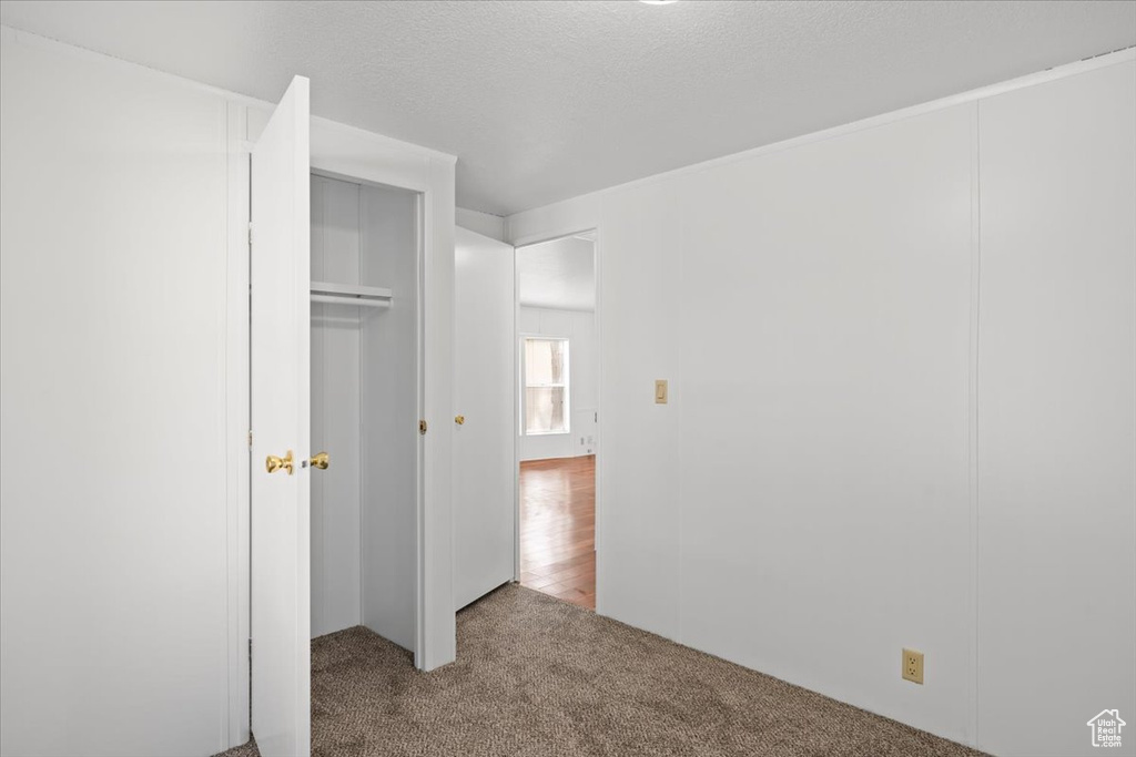 Unfurnished bedroom with carpet floors and a closet