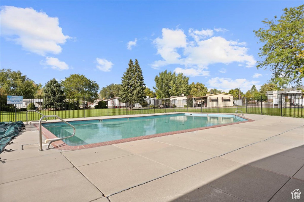 Community pool with a patio