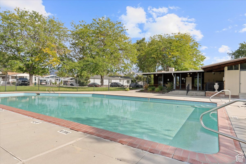 Community pool with fence and a patio