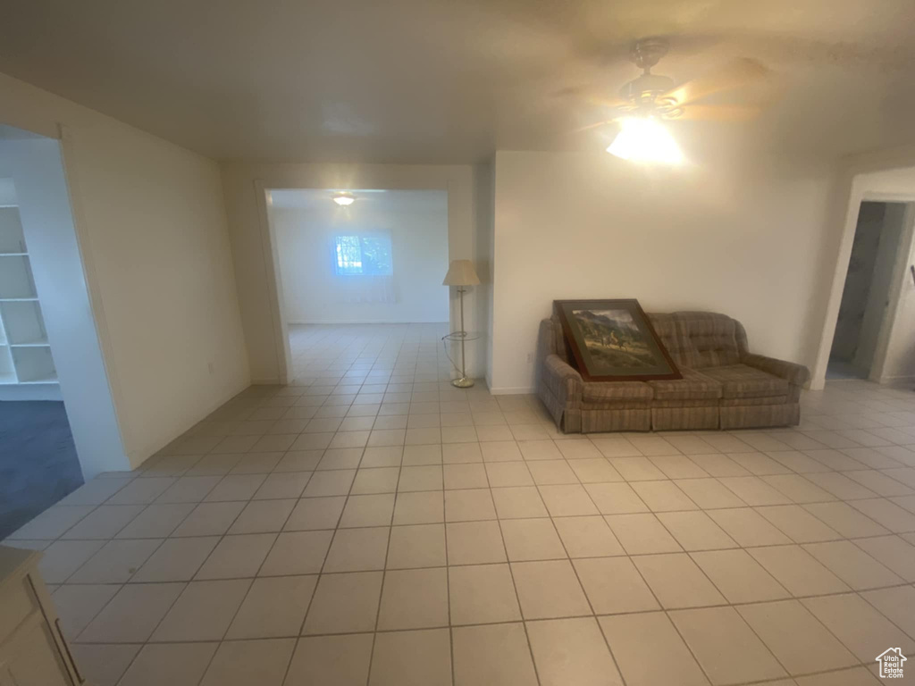 Living area with light tile patterned flooring and ceiling fan