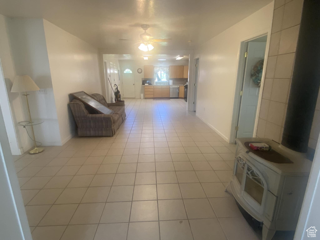 Hallway featuring light tile patterned floors and baseboards