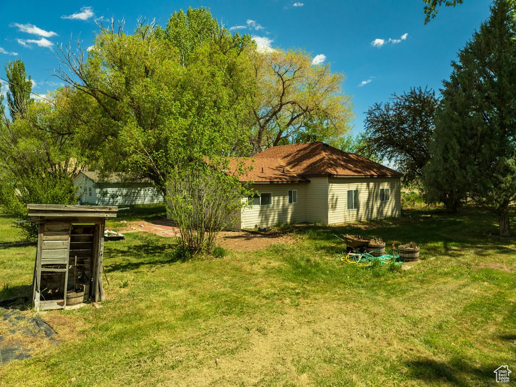 Back of house with a lawn