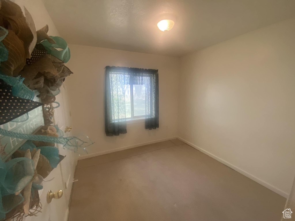 Unfurnished bedroom with baseboards and carpet