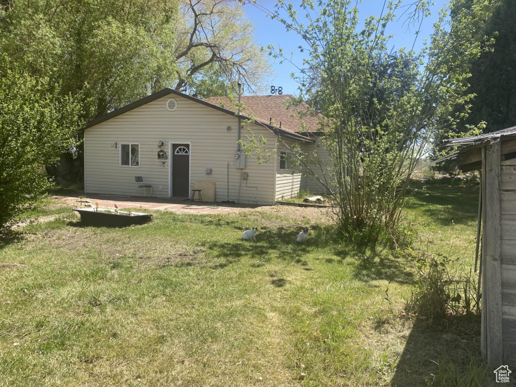 Rear view of property with a lawn