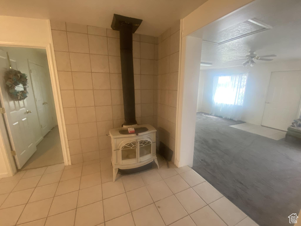 Detailed view of a wood stove, tile walls, and carpet