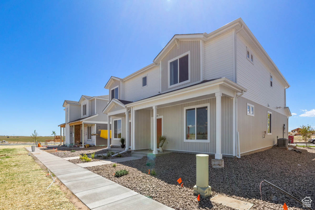 View of front of house with covered porch and central air condition unit