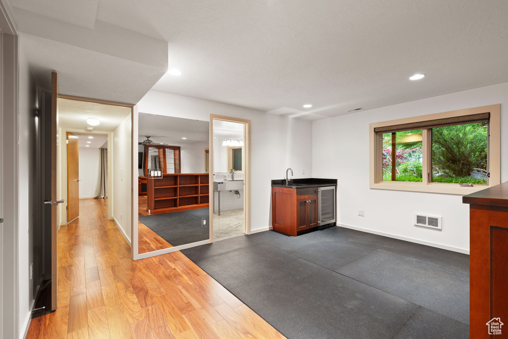 Interior space featuring visible vents, indoor wet bar, baseboards, and recessed lighting