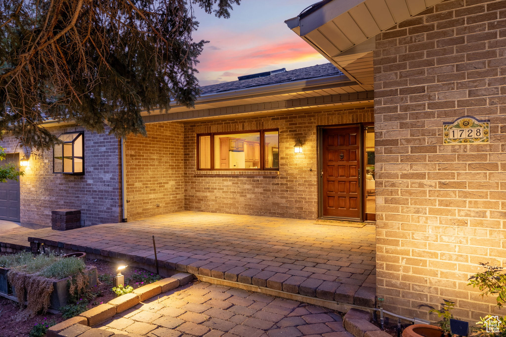 View of exterior entry featuring brick siding