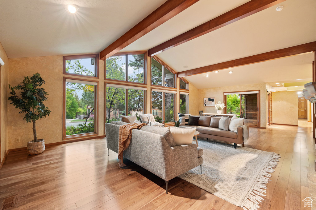 Living room with light wood-type flooring and baseboards
