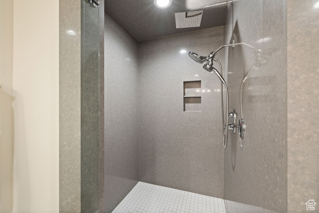 Full bathroom with tile patterned flooring, tiled shower, and recessed lighting