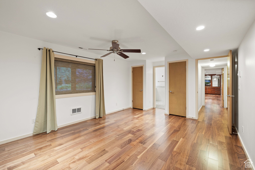 Empty room featuring light wood-style floors, visible vents, a ceiling fan, and recessed lighting