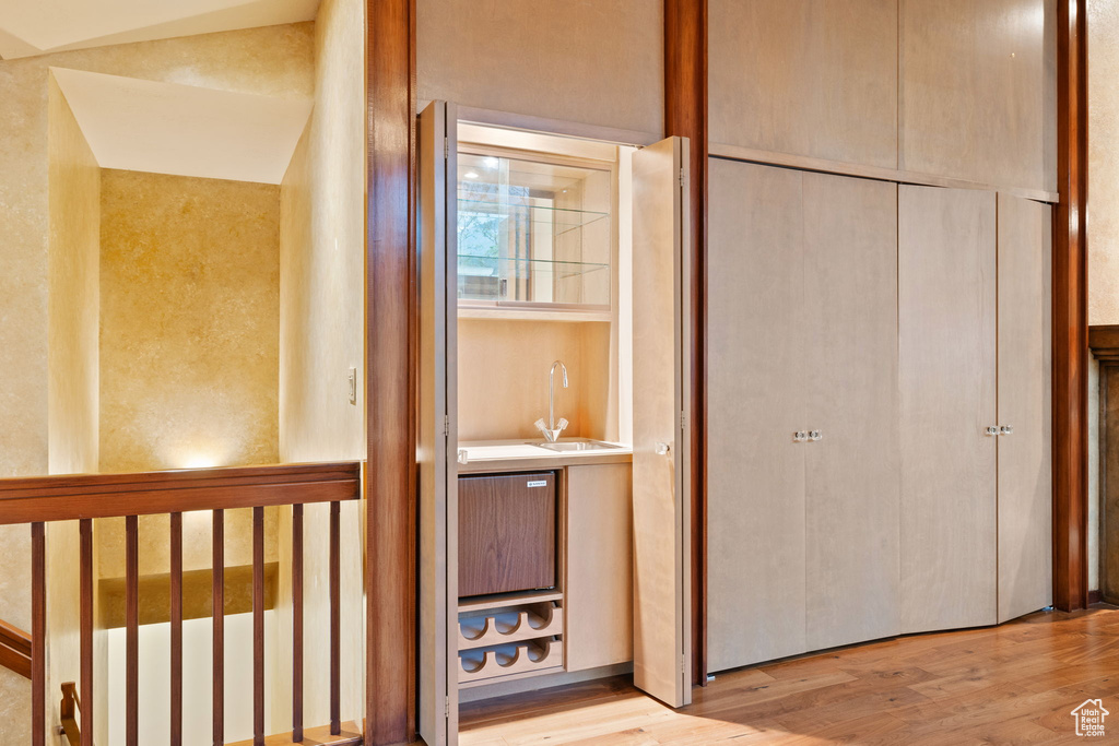 Hallway with light wood-style floors and a sink