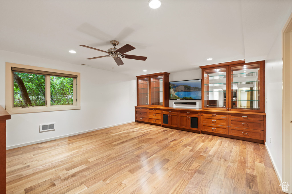 Unfurnished living room with light wood-style flooring, a ceiling fan, recessed lighting, and baseboards