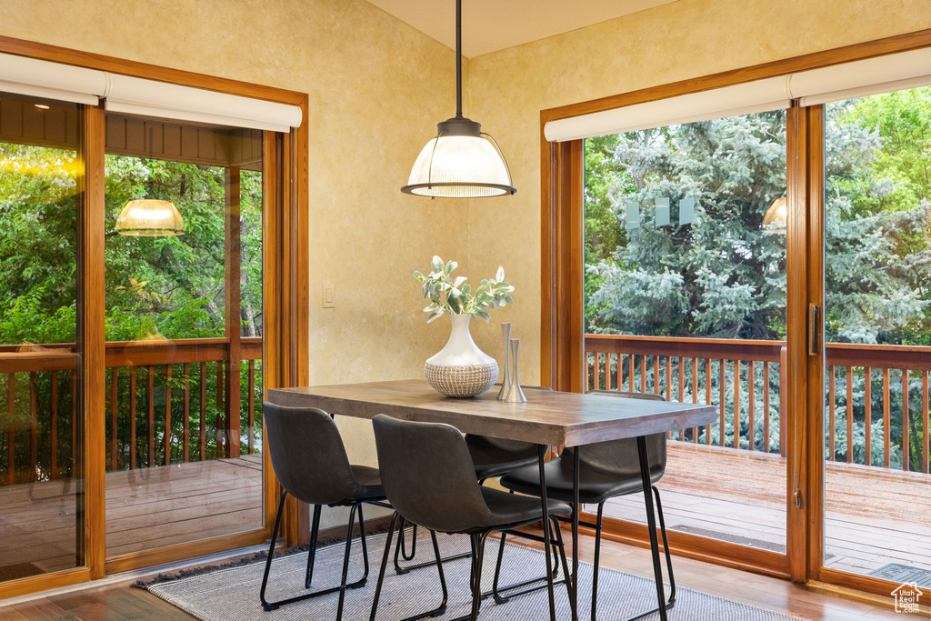 Dining area with wood finished floors and a textured wall