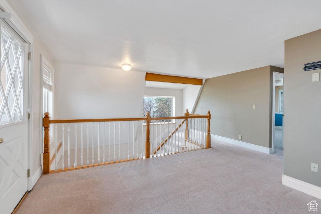 Empty room with carpet flooring and baseboards