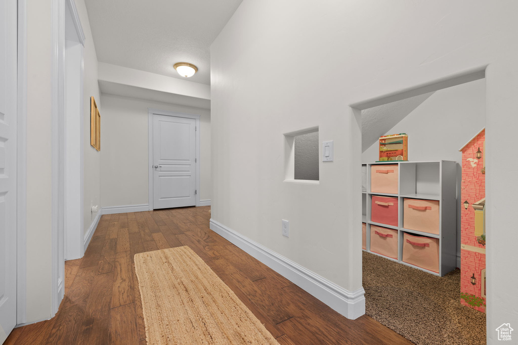 Hall featuring wood finished floors and baseboards
