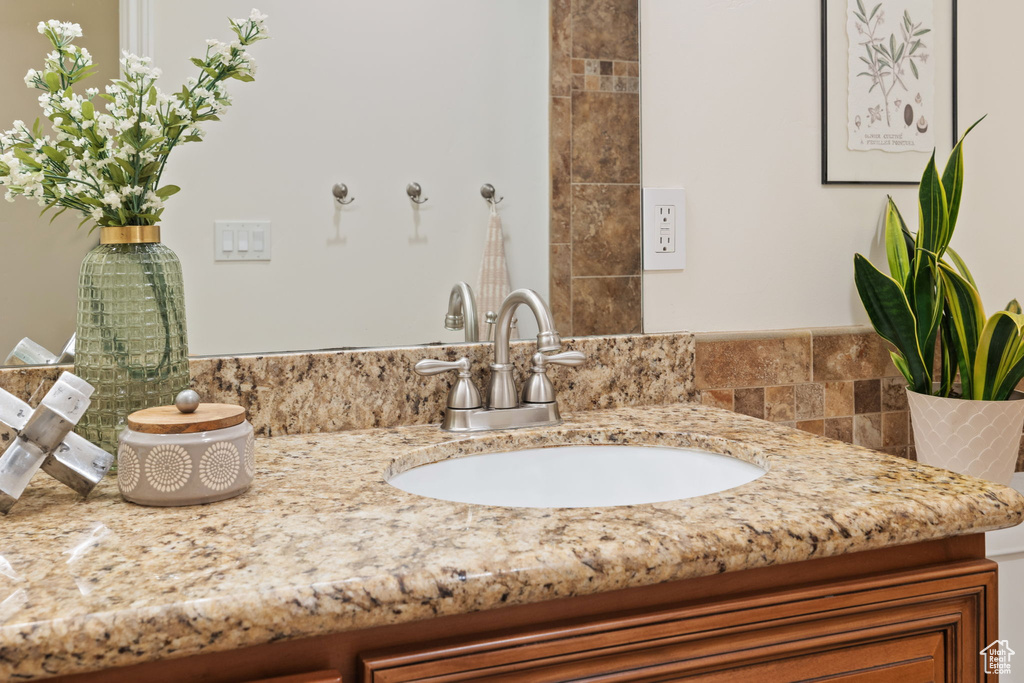 Bathroom with vanity and decorative backsplash