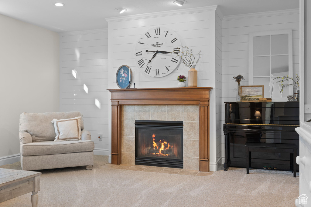 Sitting room featuring carpet flooring, crown molding, a fireplace, and recessed lighting