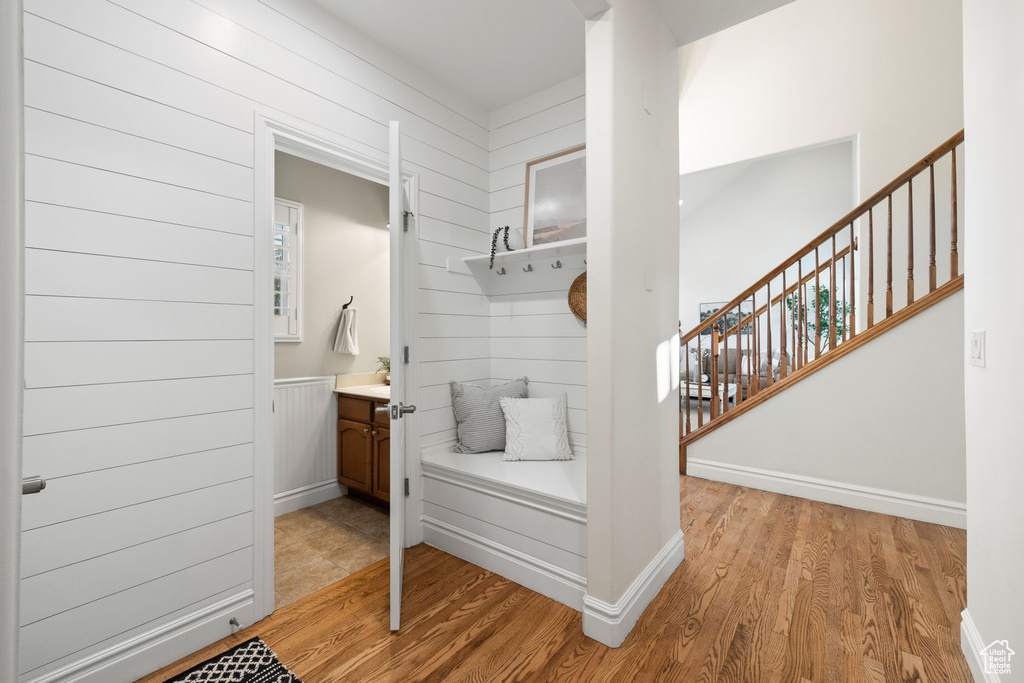 Mudroom with light wood-style flooring and baseboards
