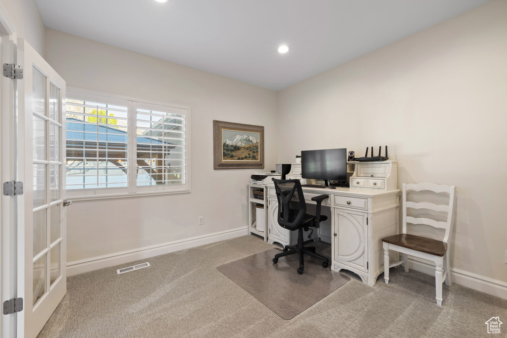 Office space featuring light colored carpet, baseboards, recessed lighting, and french doors