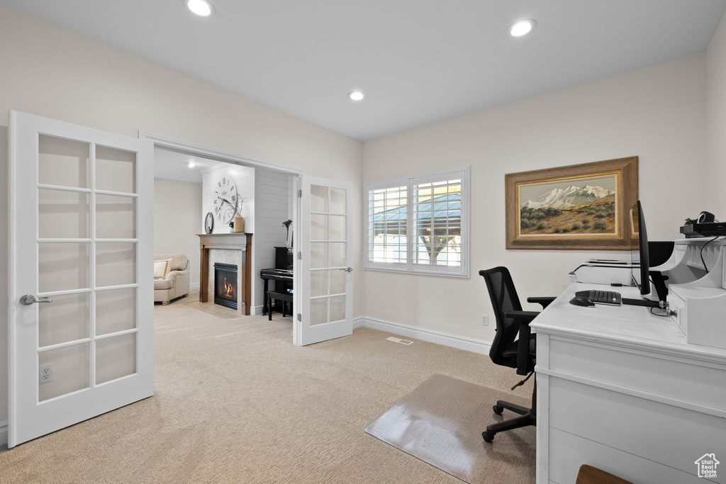 Office with french doors, light colored carpet, recessed lighting, a tile fireplace, and baseboards