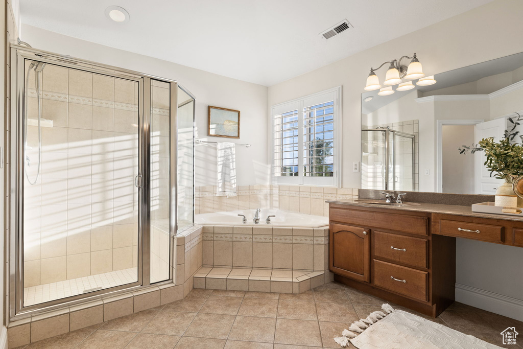 Bathroom featuring a stall shower, a garden tub, tile patterned flooring, and vanity