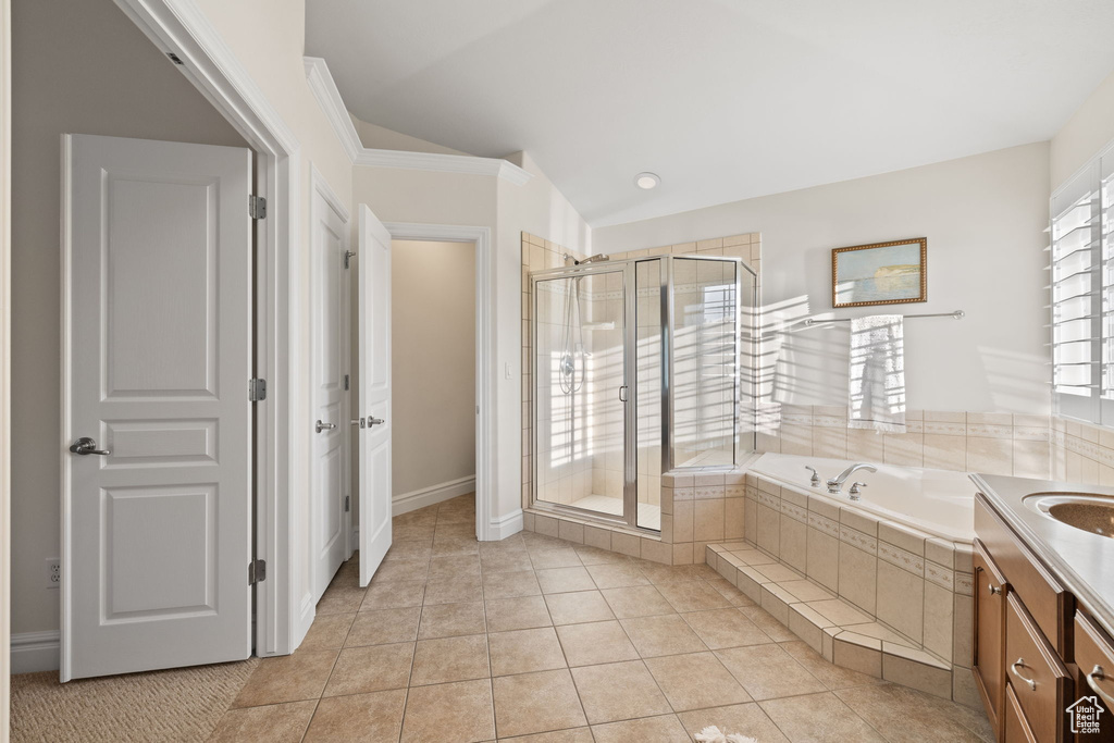 Full bath with a shower stall, a garden tub, vanity, tile patterned flooring, and ornamental molding