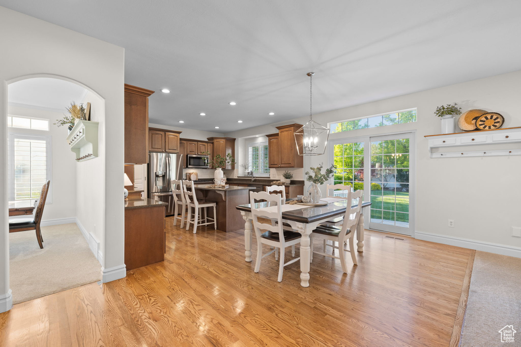 Dining space featuring healthy amount of natural light, light wood-style floors, recessed lighting, and baseboards