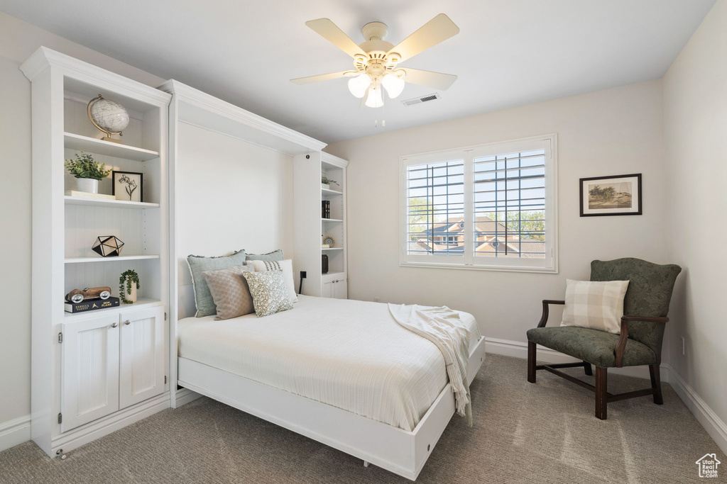 Bedroom with carpet, baseboards, and a ceiling fan