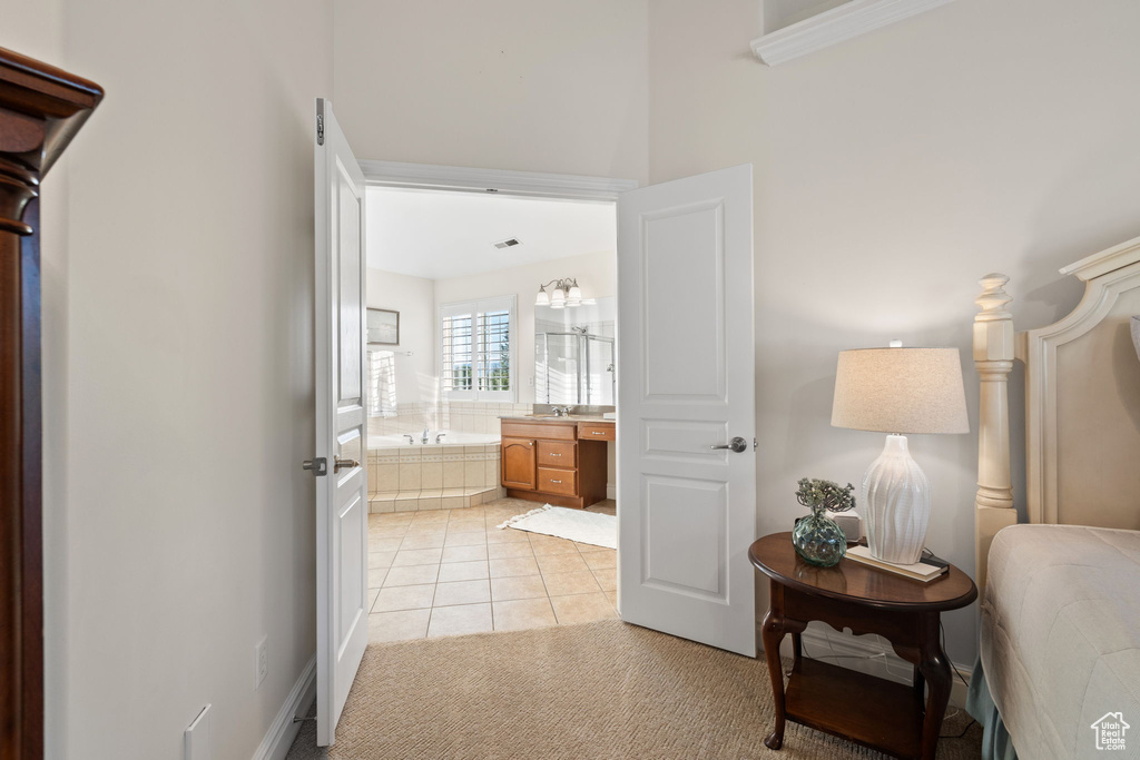 Full bath featuring a bath, vanity, and tile patterned flooring