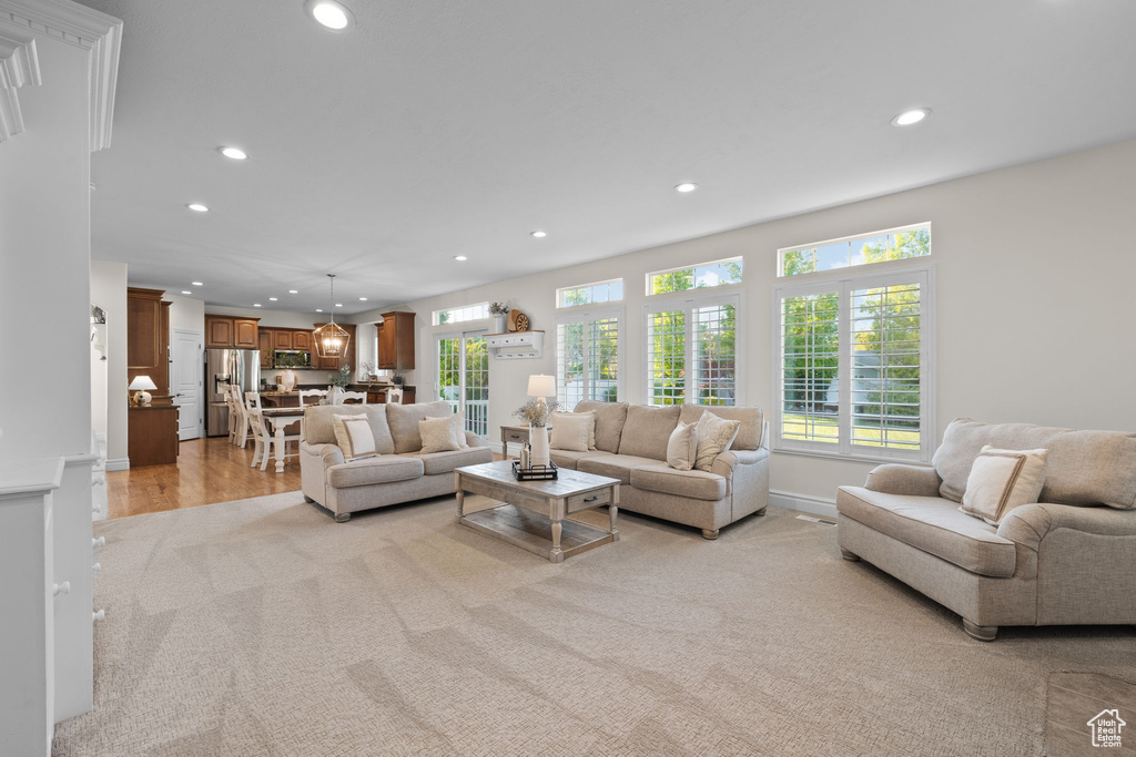 Living room featuring recessed lighting, light carpet, and baseboards