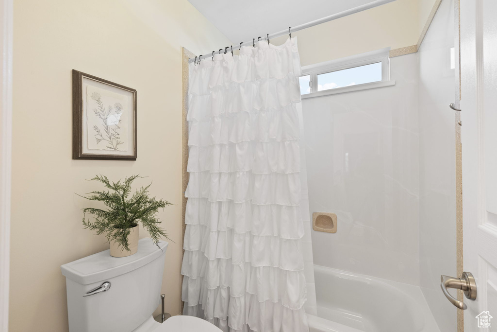 Bathroom with toilet and shower / tub combo